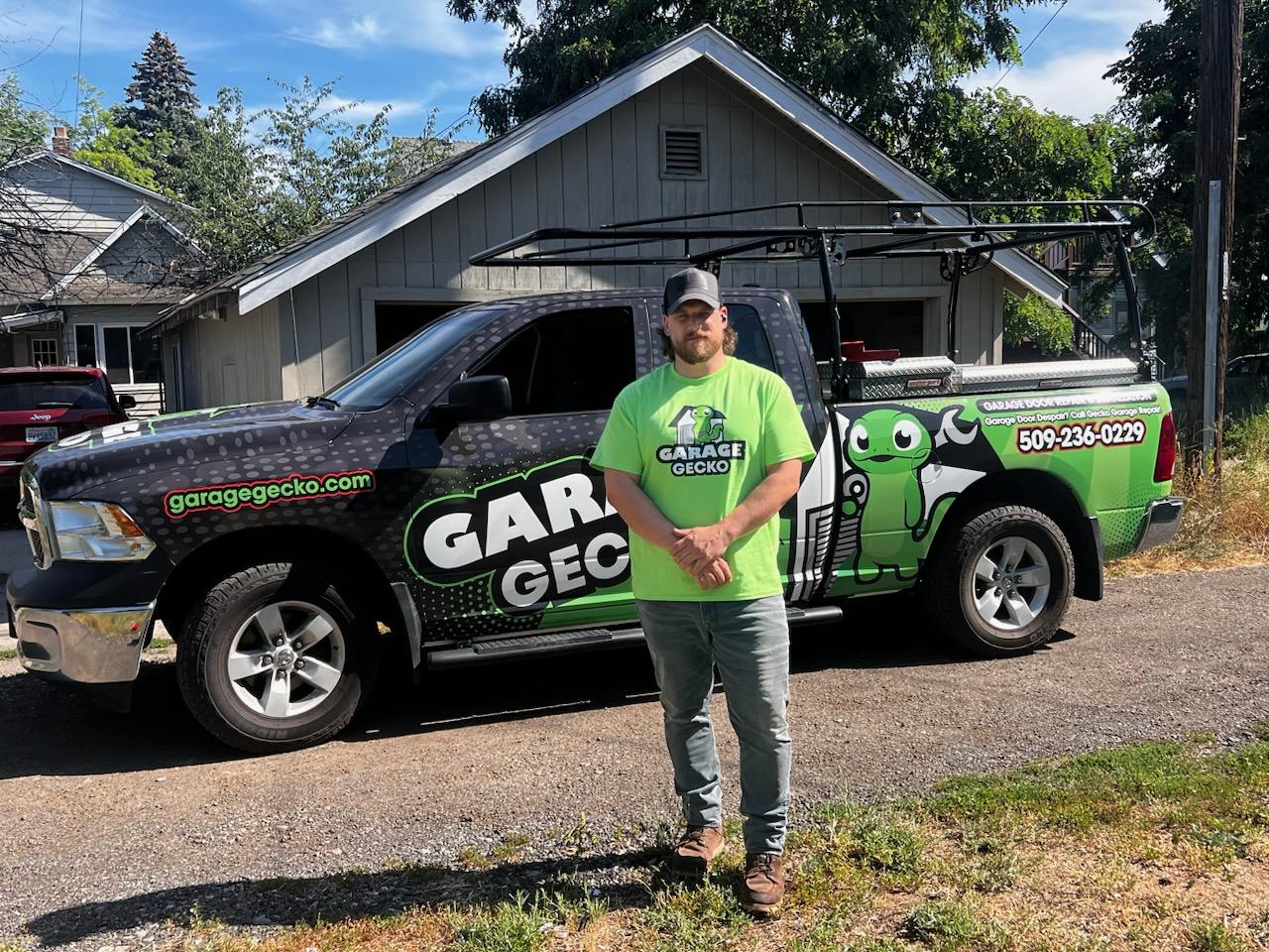 Stephen Beck - the owner of Garage Gecko Garage Door Repair standing in front of a branded truck.